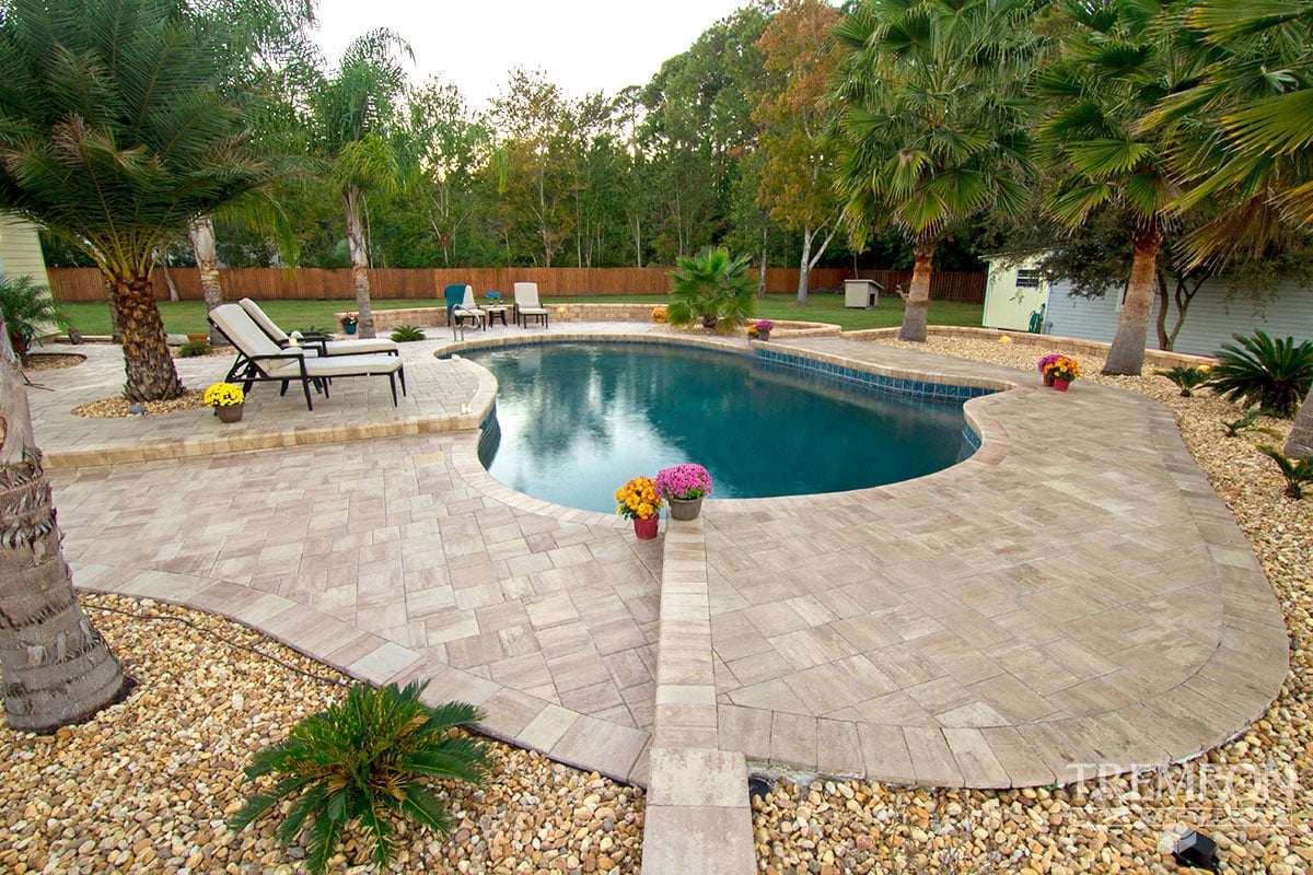 A pool deck and walkway laid in light Tremron Stonehurst concrete pavers
